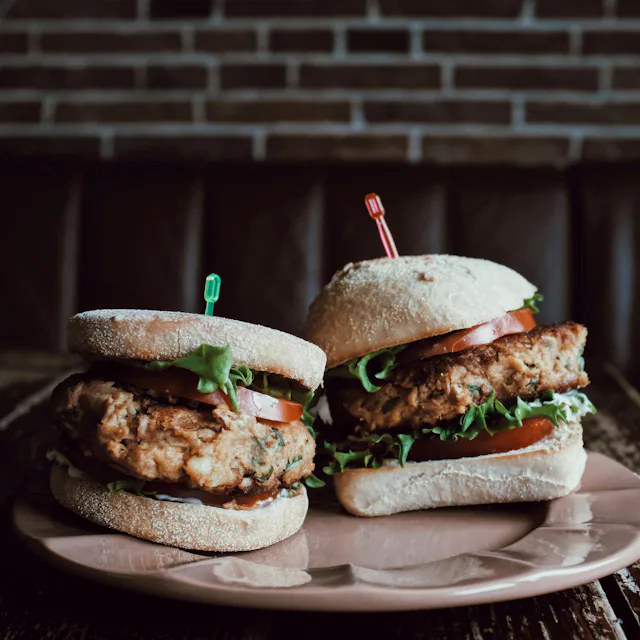 Two burgers served on a board