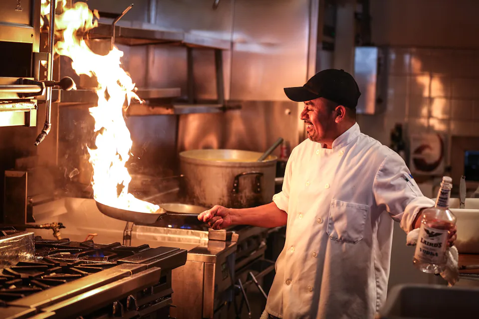 A chef cooking over a flame