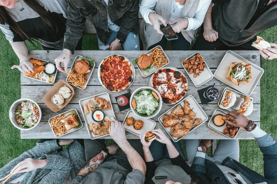Friends sharing plates around a table