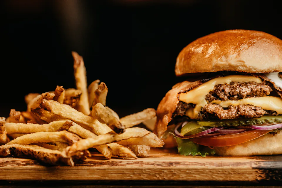 A burger and fries on a board