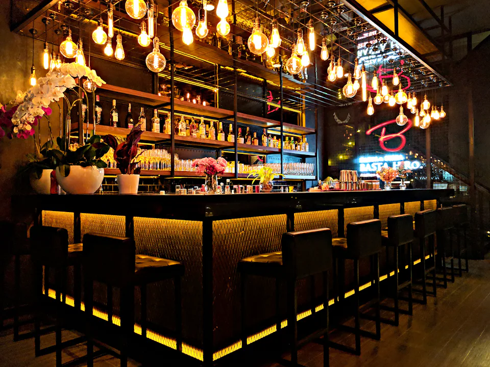 A taproom bar lit with hanging bulbs